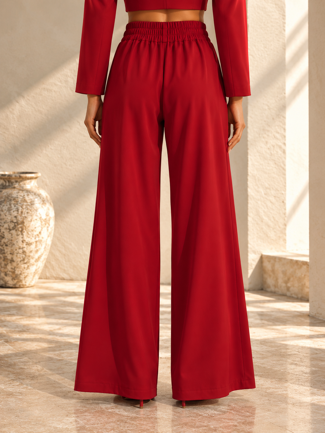 Back view of red wide-leg trousers with high-rise waistband
