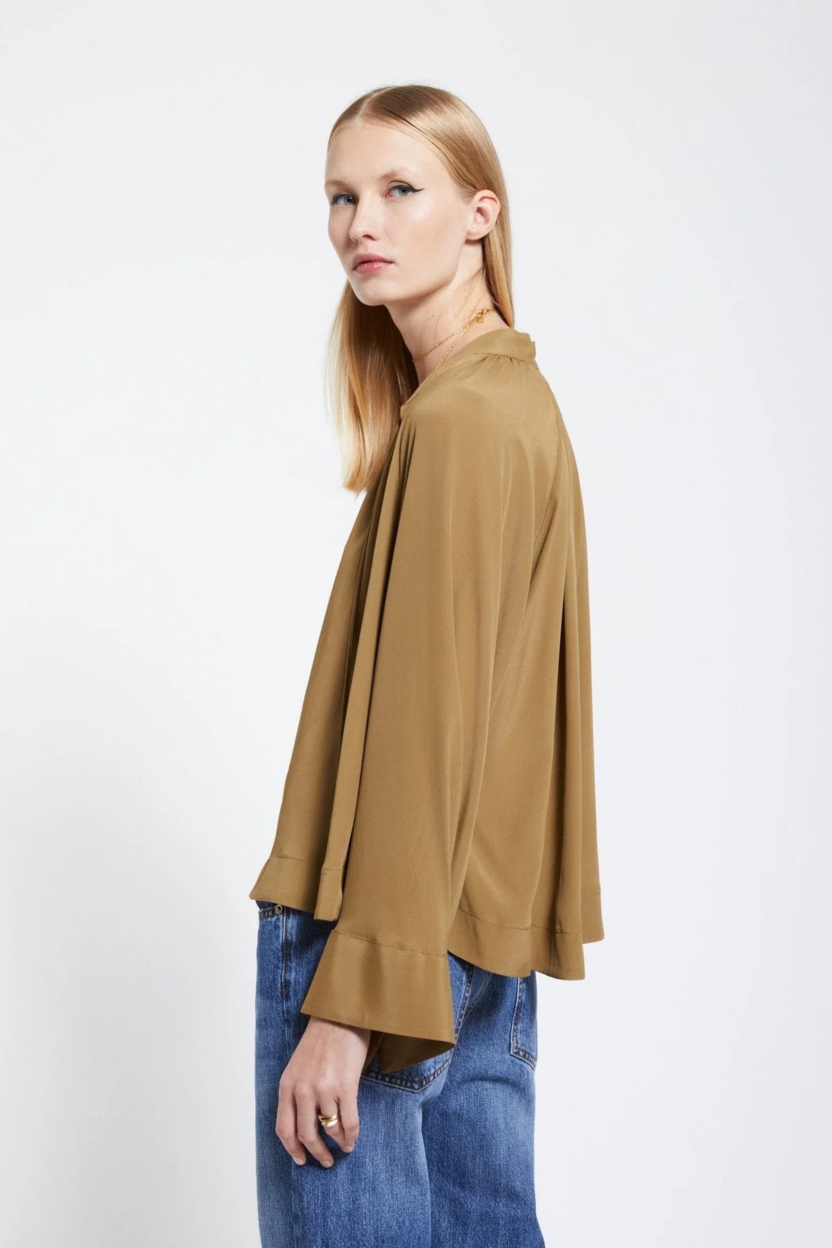 Side view of Ottod’Ame khaki brown silk-blend blouse with flared silhouette