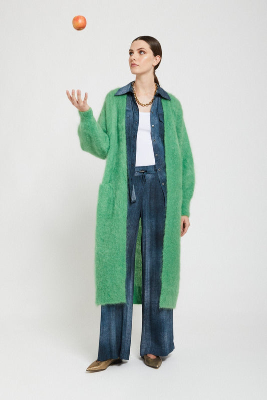 Model wearing the Ottod’Ame green long mohair cardigan styled with dark denim and a white top.