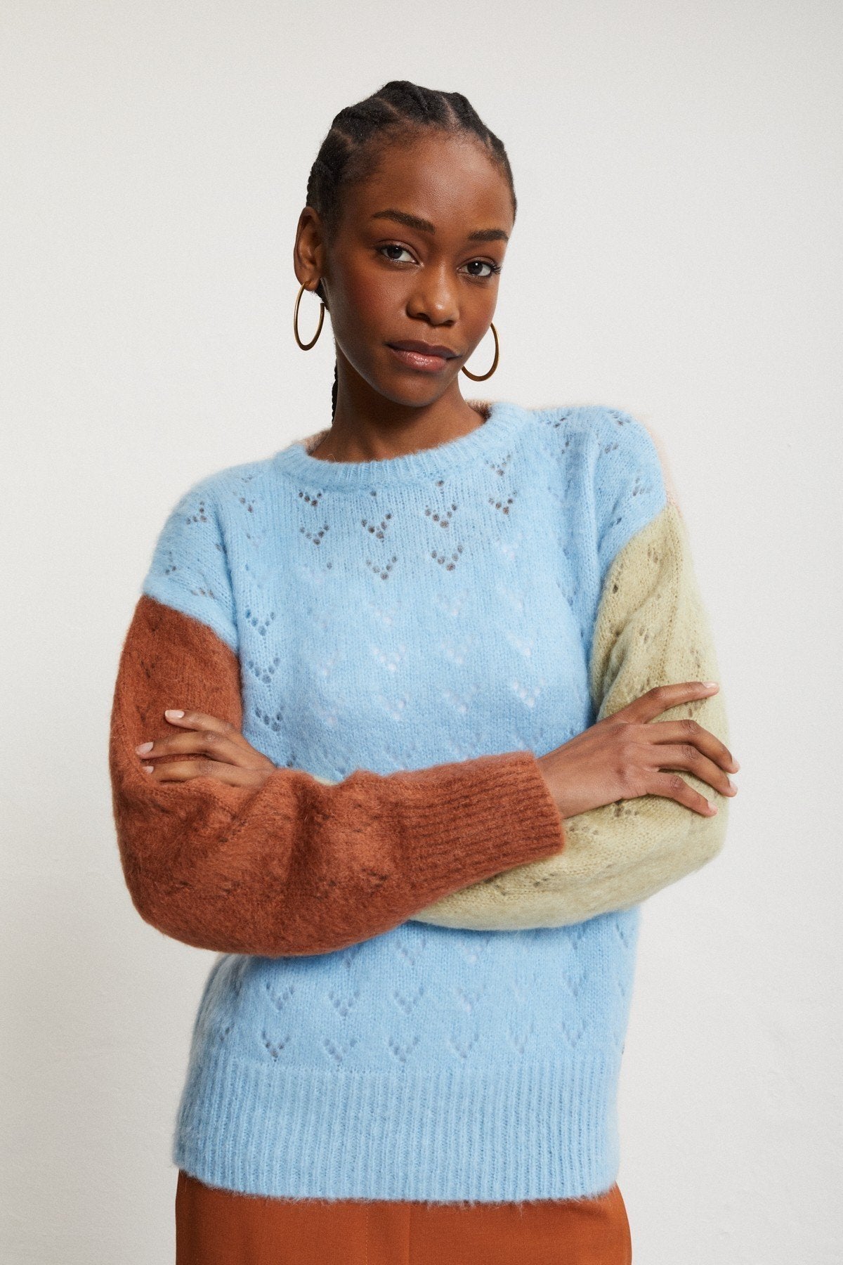 Ottod’Ame multicolor mohair jumper styled with rust-coloured trousers, showing the relaxed fit and contrasting sleeves.