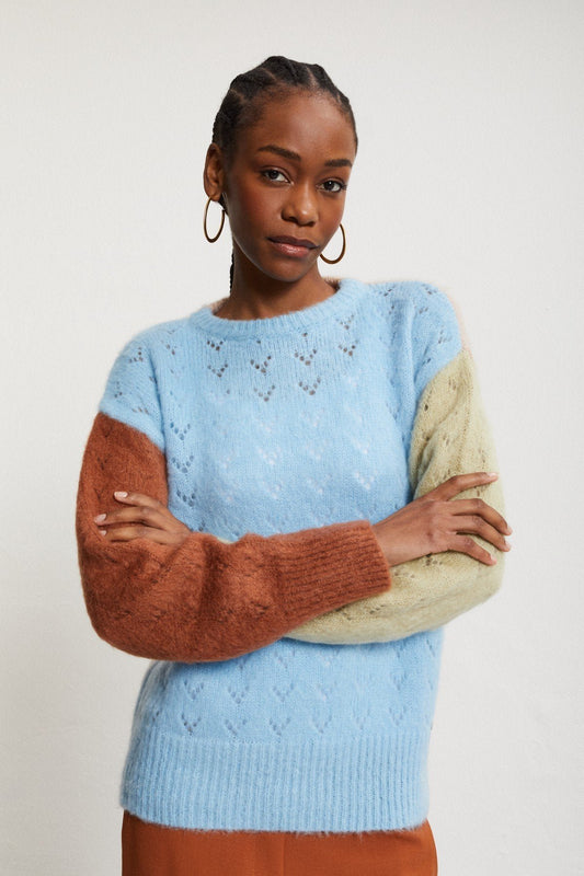 Ottod’Ame multicolor mohair jumper styled with rust-coloured trousers, showing the relaxed fit and contrasting sleeves.