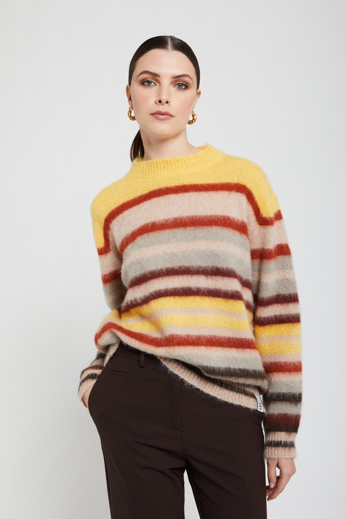 Model wearing an Ottod’Ame striped mohair blend jumper with black trousers, front view.