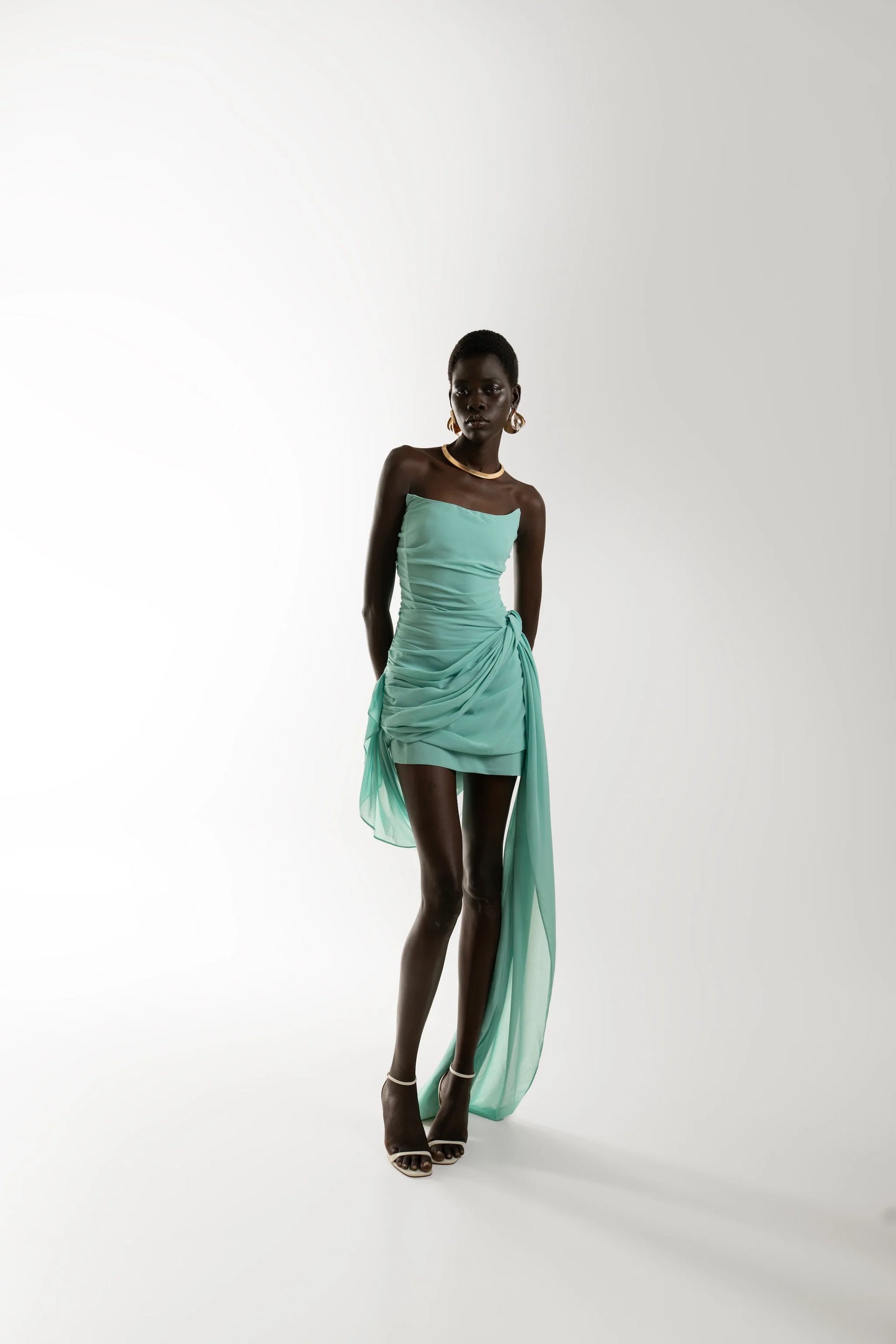 TALA turquoise mini dress with asymmetric strapless neckline and draped chiffon detail.