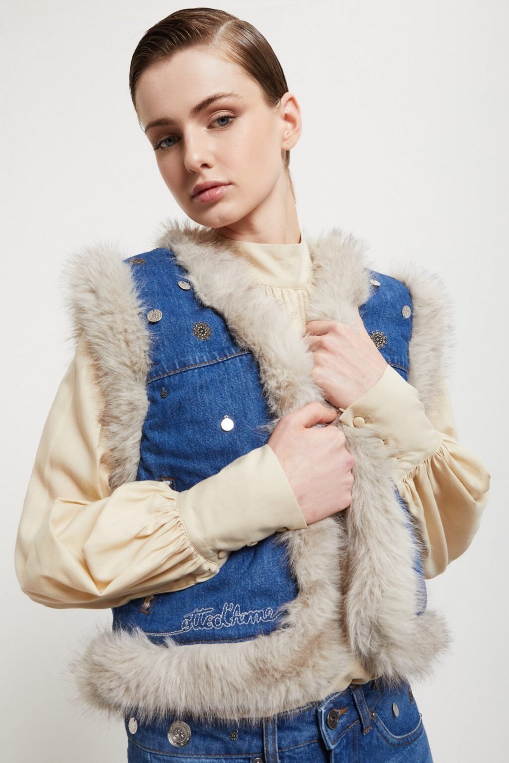 Model wearing Ottod’Ame reversible denim and faux fur vest