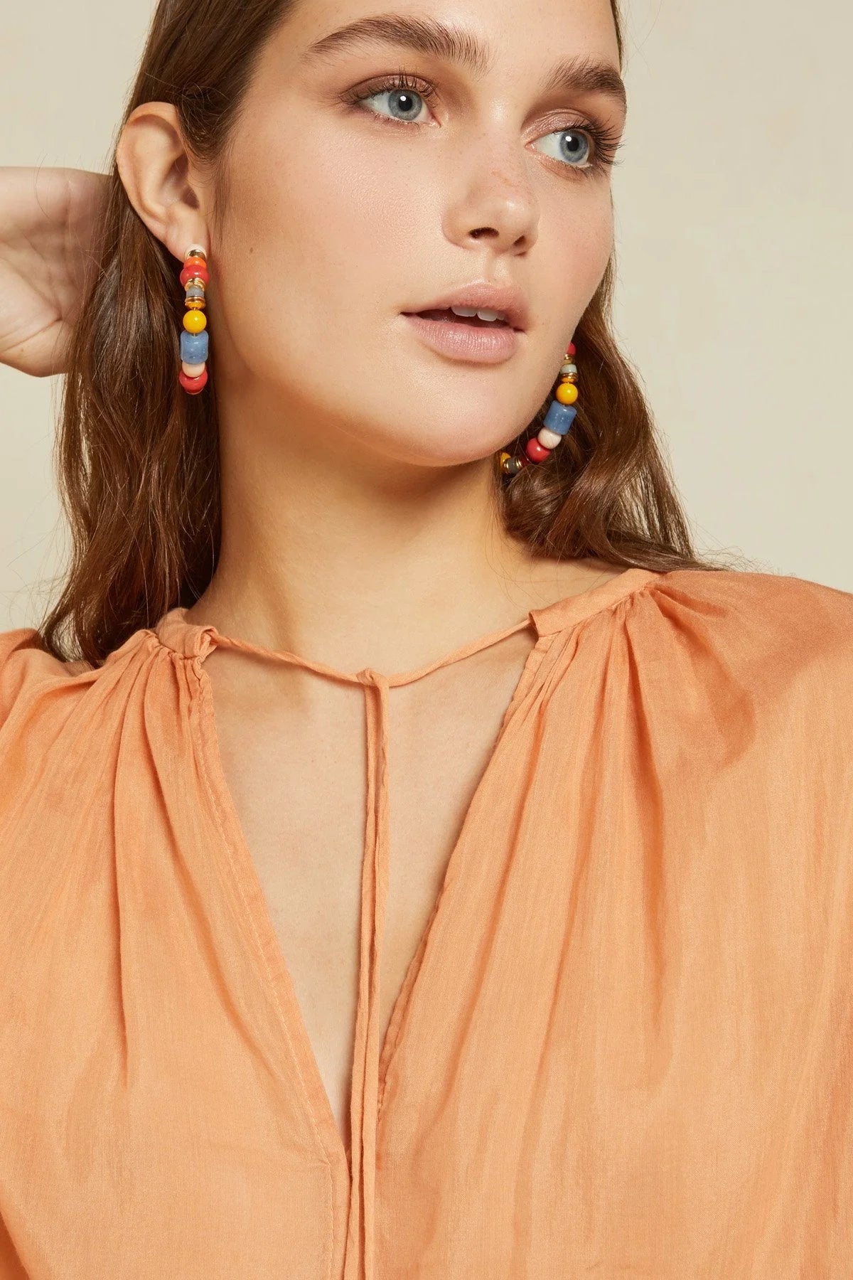 Detail of silk blend peach blouse fabric and neckline ties