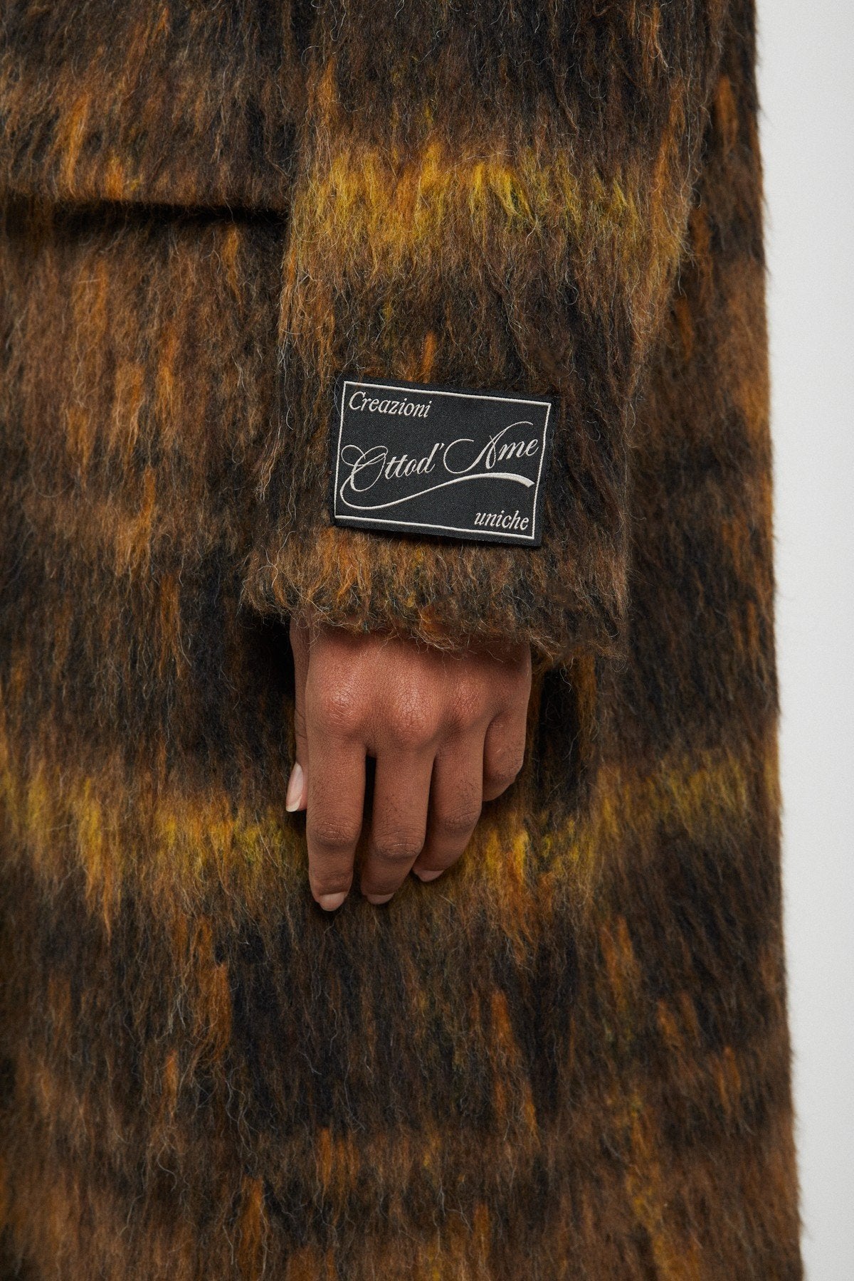 Detailed view of the textured fabric and Ottod'Ame sleeve label.