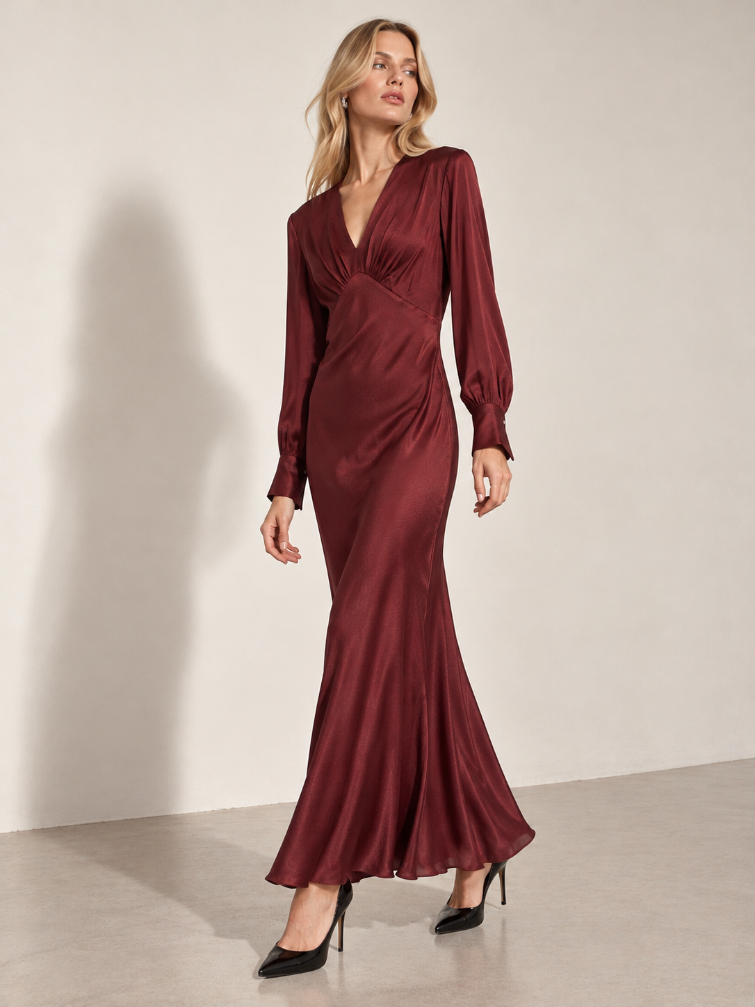 Ottod'Ame burgundy satin maxi evening dress with long sleeves and a V-neckline.