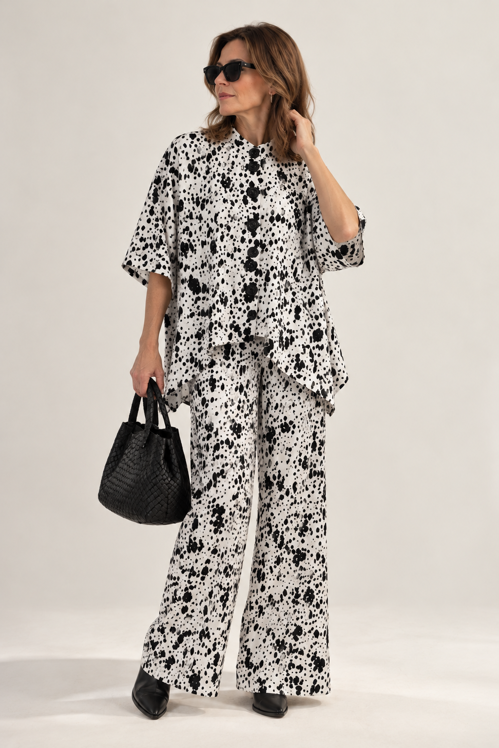 Fioroula Dalmatian print wide-leg trousers styled with matching blouse in white and black