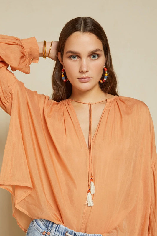 Model wearing sunwashed silk blend peach blouse by Ottod'Ame