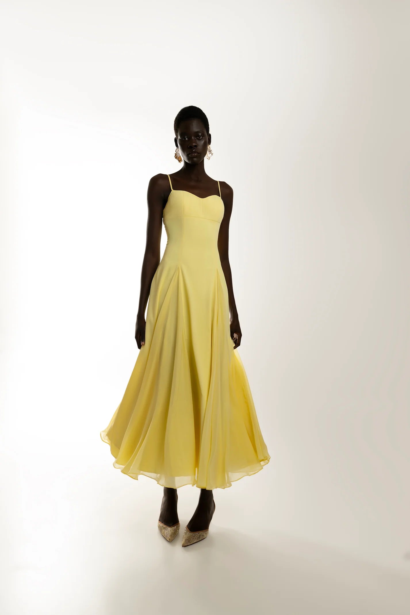Yellow A-line maxi dress in motion, lightweight fabric and feminine silhouette. Sophiel
